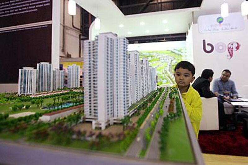 A boy looks at a model of Jaypee Greens project at the Indian Property Show at the Dubai World Trade Centre. Developers confirm interest  in real estate has increased due to favourable exchange rates.