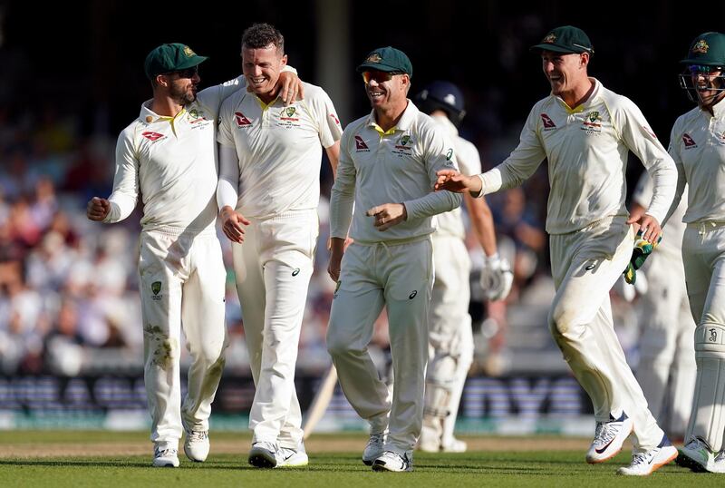 Australia bowler Peter Siddle, second left, celebrates after taking  the wicket of Joe Denly. PA