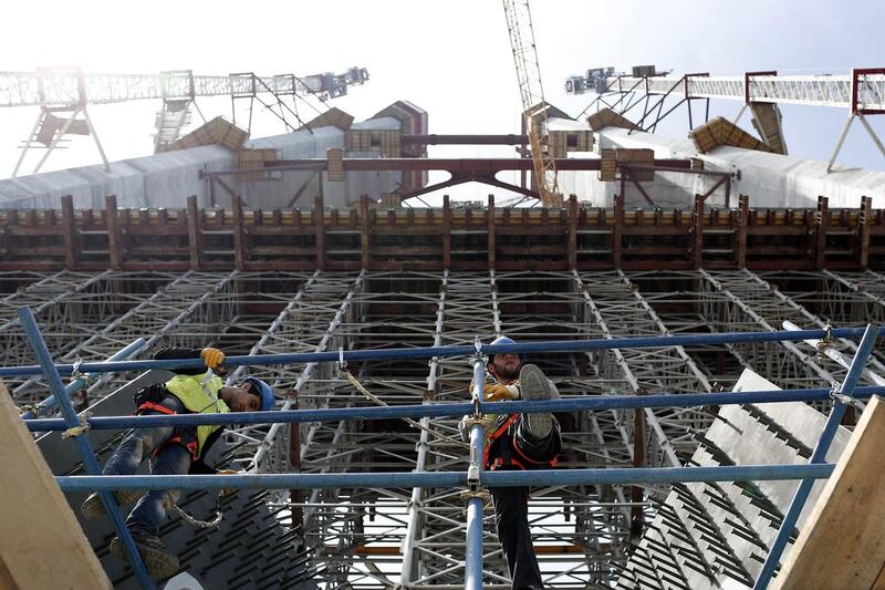 Construction workers perform their duties at the construction site of the Yavuz Sultan Selim Bridge. Sedat Suna / EPA