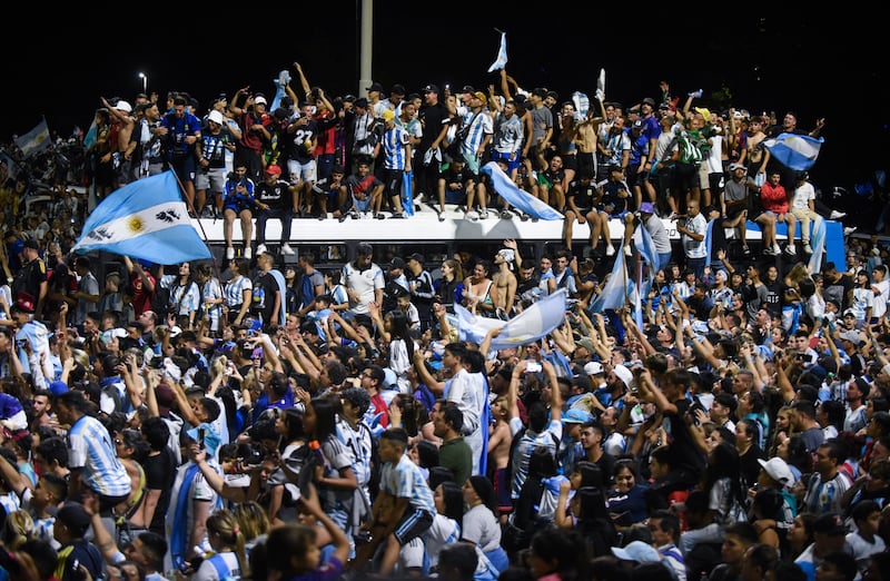 Fans gather outside the Argentinian Football Association headquarters awaiting the team bus to arrive. Reuters