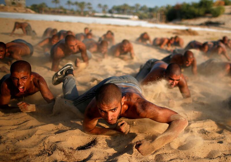 Palestinian cadets crawl as they demonstrate their skills at a police college run by the Hamas-led interior ministry in Khan Younis in the southern Gaza Strip. Reuters