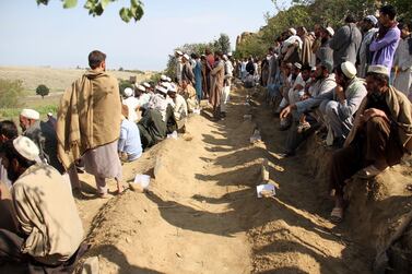 Afghan men bury victims of Friday's deadly bomb blast in the mosque in the village of Jodari at Haskamena district of Jalalabad east of Kabul, Afghanistan, Saturday, Oct. 19, 2019. Funerals are being held in eastern Afghanistan for the victims of Friday's deadly bomb blast in a village mosque which killed 62 people during prayers. (AP Photo/Wali Sabawoon)