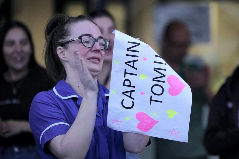 LIVERPOOL,  UNITED KINGDOM- APRIL 16:  A nurse at Aintree University Hospital sheds a tear and as she pays tribute to super fundraiser Captain Tom Moore during the "Clap for Our Carers" and the NHS on April 16, 2020 in Liverpool, United Kingdom. Following the success of  the "Clap for Our Carers" campaign, members of the public are being encouraged to applaud NHS staff and other key workers from their homes at 8pm every Thursday. The Coronavirus (COVID-19) pandemic has infected over 2 million people across the world, claiming at least 13,729 lives in the U.K. (Photo by Christopher Furlong/Getty Images)
