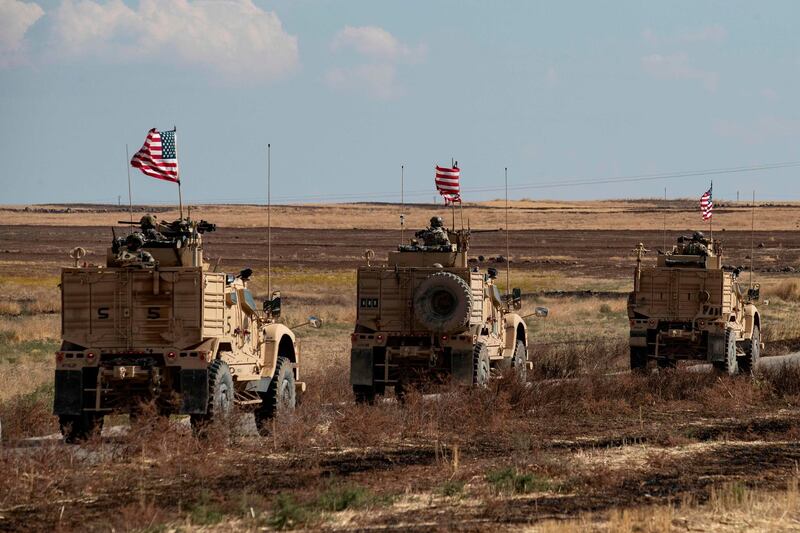 A convoy of US armoured vehicles patrols the northern countryside of the northeastern Syrian town of al-Malikiyah (Derik) at the border with Turkey, on November 3, 2019.  / AFP / Delil SOULEIMAN
