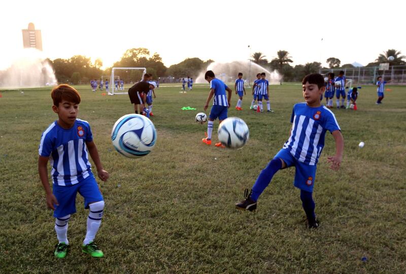 Iraqi boys practice keepie-uppies during a training session at the Espanyol Football Academy in Baghdad. EPA