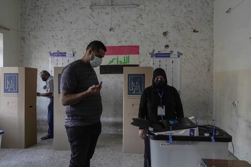 The first voter to arrive at a polling station in Karadah, central Baghdad, casts his vote. Photo: Haider Husseini / The National