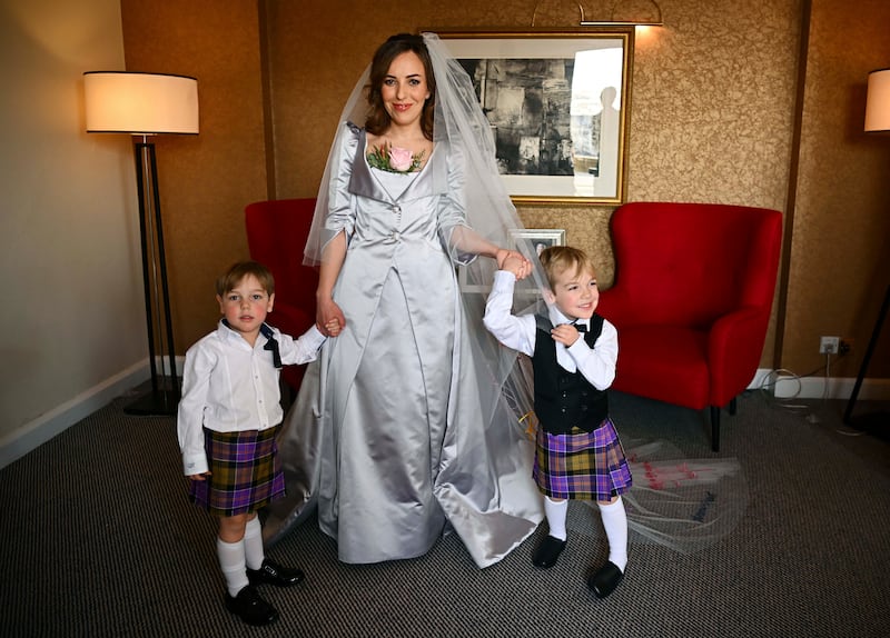 Ms Moris is photographed in her Vivienne Westwood wedding dress, with sons Max, 3, and Gabriel, 4. AP Photo
