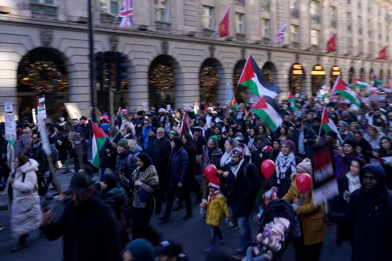 Protesters carry Palestinian flags. AP