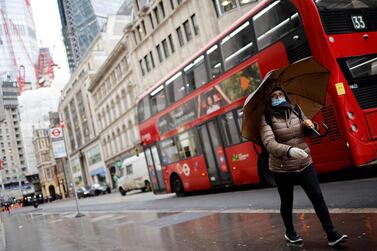 A lone pedestrian walks through the City of London. The third lockdown in England along with a sharp increase in border controls following Britain’s exit from the European Union will force the UK's GDP downwards in the first quarter of this year. AFP