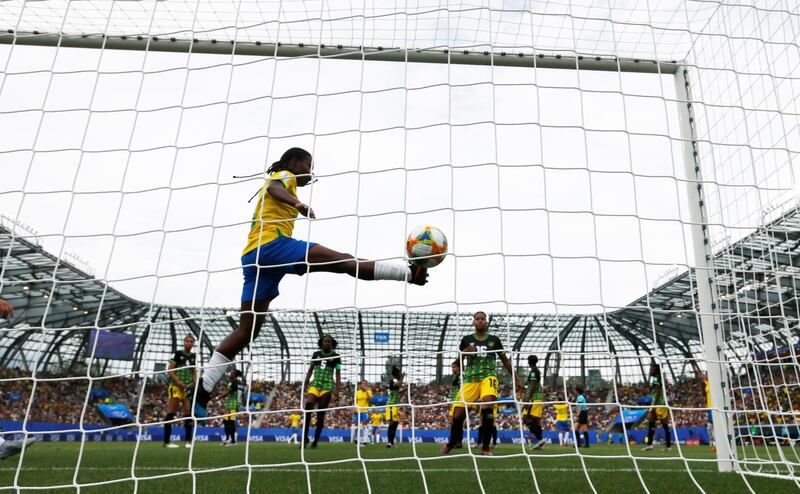 Brazil's Cristiane scores their third goal from a free kick to complete her hat-trick. Reuters