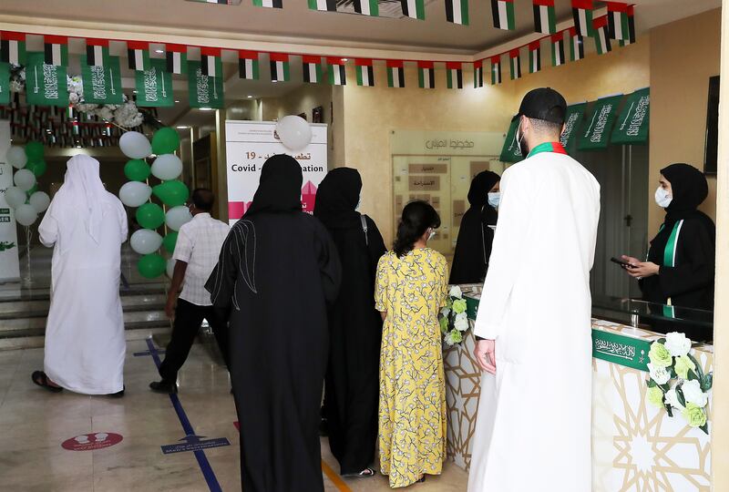 People arrive at the vaccination centre to receive shots of either Sinopharm or Pfizer-BioNTech.