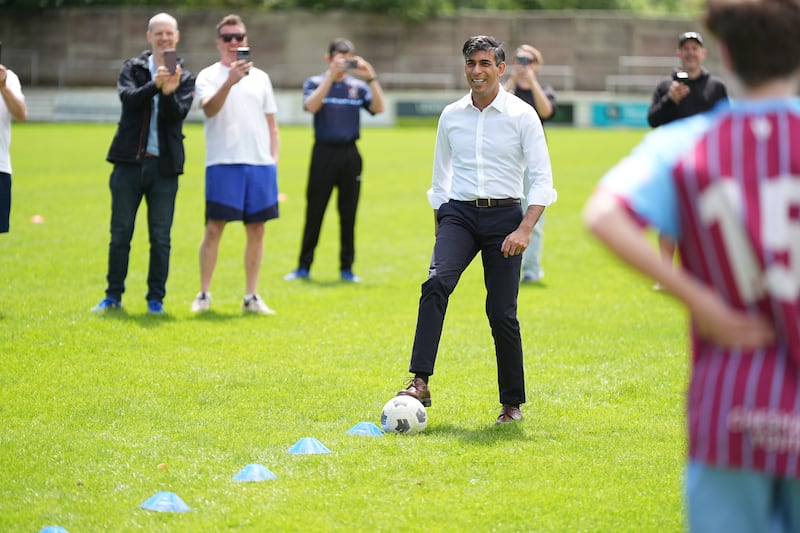 Mr Sunak on the ball during a visit to Chesham United Football Club. PA