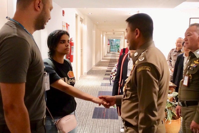 Saudi teen Rahaf Mohammed al-Qunun is greeted by Thai immigration authorities at a hotel inside Suvarnabhumi Airport in Bangkok, Thailand January 7, 2019. Thailand Immigration Police via REUTERS ATTENTION EDITORS - THIS IMAGE WAS PROVIDED BY A THIRD PARTY. NO RESALES. NO ARCHIVES. THAILAND OUT. NO COMMERCIAL OR EDITORIAL SALES IN THAILAND. TPX IMAGES OF THE DAY