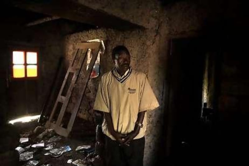 Joseph Akwamungu in his house that was wrecked by rebels.