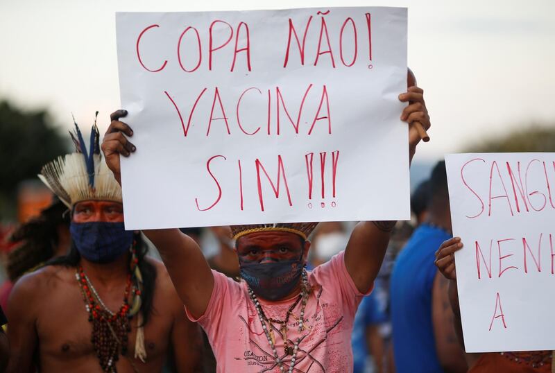 Indigenous Brazilians protest against their country hosting the Copa America football tournament amid the Covid-19 pandemic. The placard reads "Copa no! Vaccine yes!" Reuters
