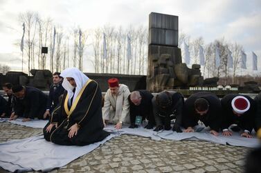Sheikh Mohammad Abdulkarim Al Issa, secretary general of the Muslim World League, leads prayers next to the memorial monument in the former German Nazi death camp Auschwitz-Birkenau on January 23, 2020. The visit takes place as part of events commemorating 75 years since the liberation of Auschwitz, the World War II death camp where the Nazis killed more than 1.1 million people, most of them Jews AFP