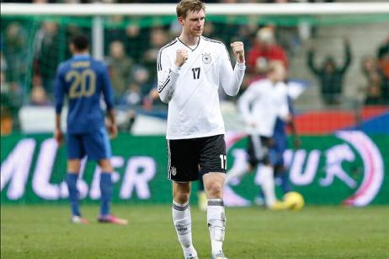 Germany defender Per Mertesacker celebrates his team's winning goal against France.