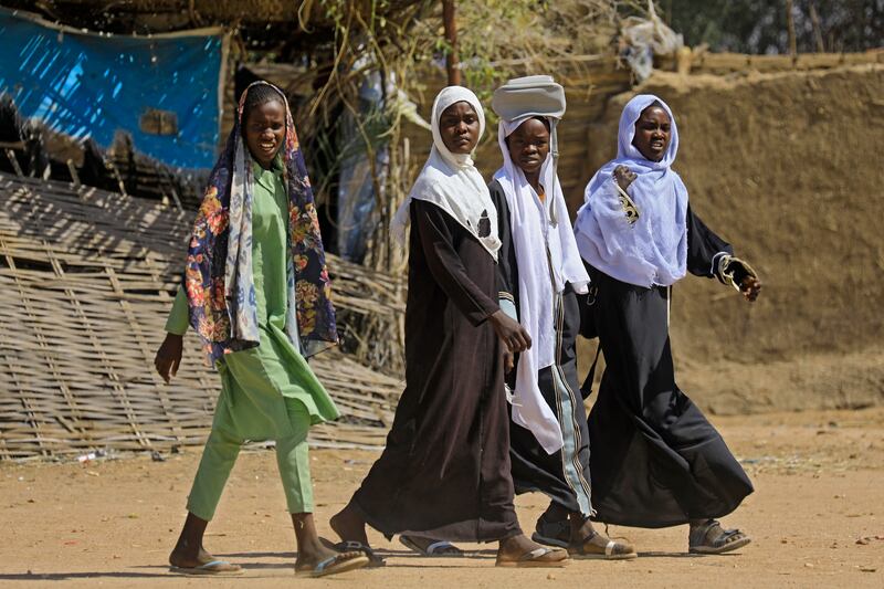 Young Sudanese women walk in the Otash camp for internally displaced people near Nyala town, the capital of South Darfur. Two thirds of young Sudanese people said they want to live in the UAE. Photo: Ashraf Shazly / AFP