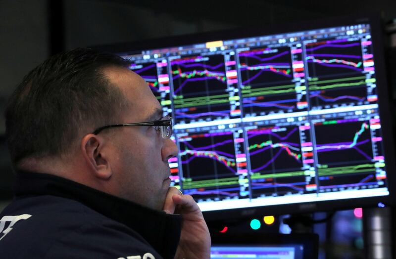 FILE PHOTO: A trader looks at price monitors as he works on the floor at the New York Stock Exchange (NYSE) in New York City, New York, U.S., December 4, 2018.  REUTERS/Brendan McDermid/File Photo GLOBAL BUSINESS WEEK AHEAD