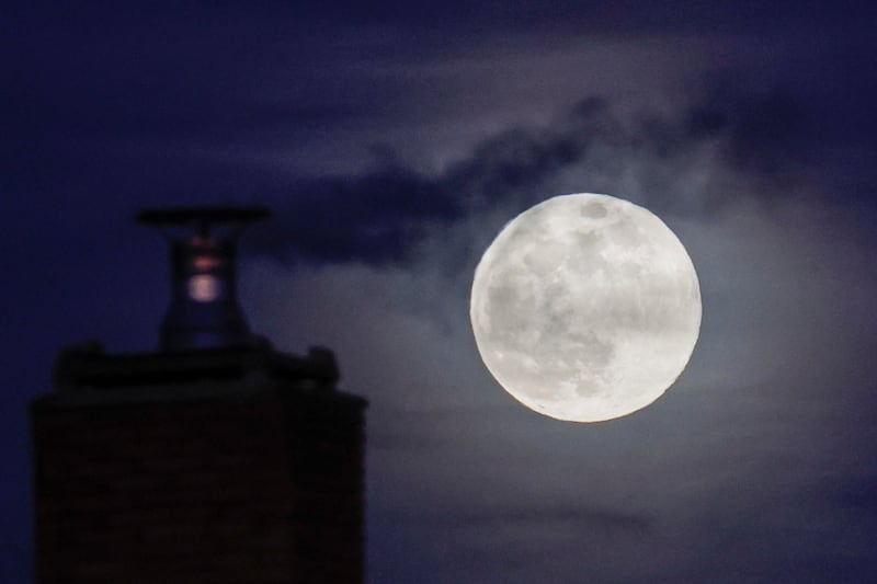 A full moon rises next to a chimney of a building in Rome, Italy, 25.  The first full moon of the year is called 'Wolf Moon. '  EPA 