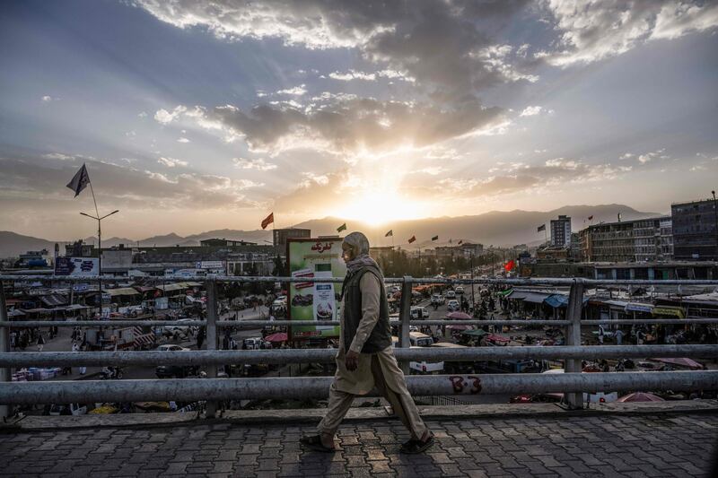 A man walks over a bridge in Kabul on August 7, 2022. AFP