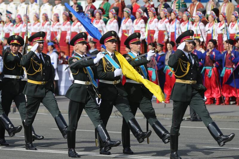 Ukrainian soldiers of a honour guard carrying a national flag march during the military parade. Tatyana Zenkovich/EPA