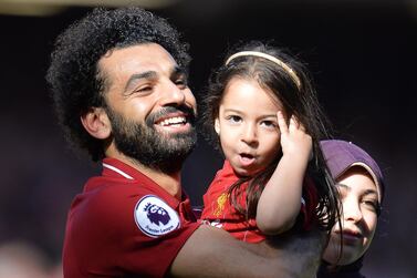 Liverpool's Mohamed Salah, left, celebrates with his daughter Makka and his wife Magi in 2019. Peter Powell / EPA