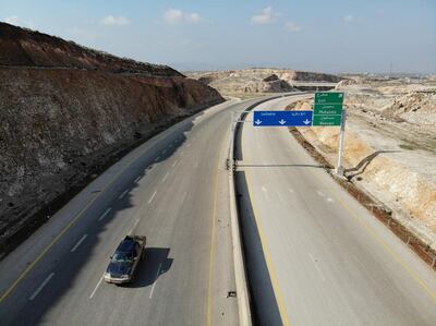 A lone vehicle drives on February 17, 2020 through the deserted M4 highway, which links the northern Syrian provinces of Aleppo and Lattakia, in Dabsanqul, south of the northwestern city of Idlib in Syria's war-battered province of the same name. Russian President Vladimir Putin and his Turkish counterpart Recep Tayyip Erdogan reached a deal after hours of talks in Moscow on March 5, 2020, including an agreement to create a security corridor along the key M4 highway in northern Syria, where Turkish and Russian forces will launch joint patrols later this month. A Russian-backed government offensive on the last rebel bastion in the country has killed hundreds of civilians since December and displaced close to a million people.
 / AFP / Omar HAJ KADOUR
