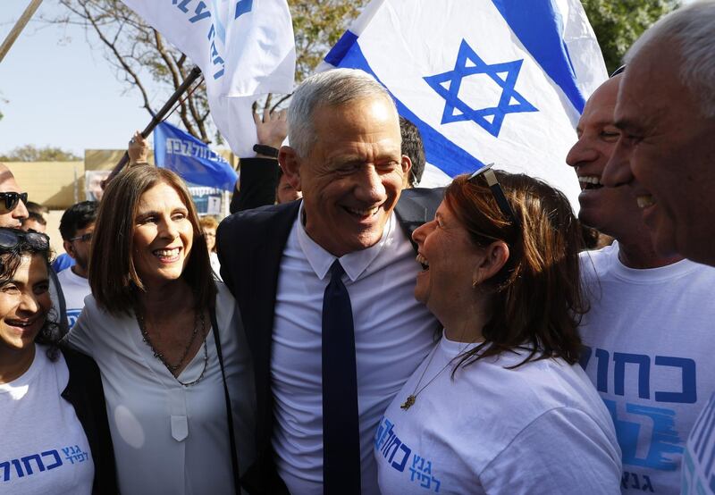 Retired Israeli general Benny Gantz, one of the leaders of the Blue and White political alliance, and his wife Revital greet supporters outside a polling station during Israel's parliamentary elections. AFP