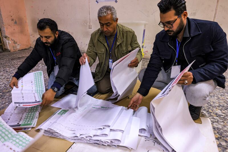 Election Commission employees count ballots at a polling station in Sadr City in east Baghdad this week. AFP