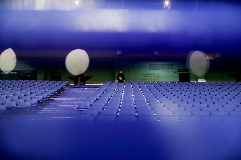 A man sits on the empty stands of La Bombonera stadium in Buenos Aires before the start of the closed-door Copa Libertadores group phase football match between Argentina's Boca Juniors and Venezuela's Caracas. AFP