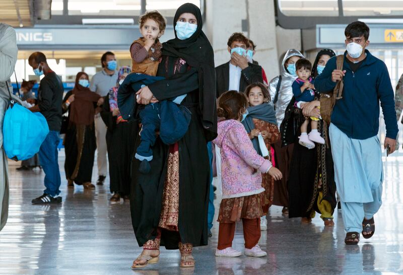 Families who fled the Taliban arrive in the US, near Washington DC. AP