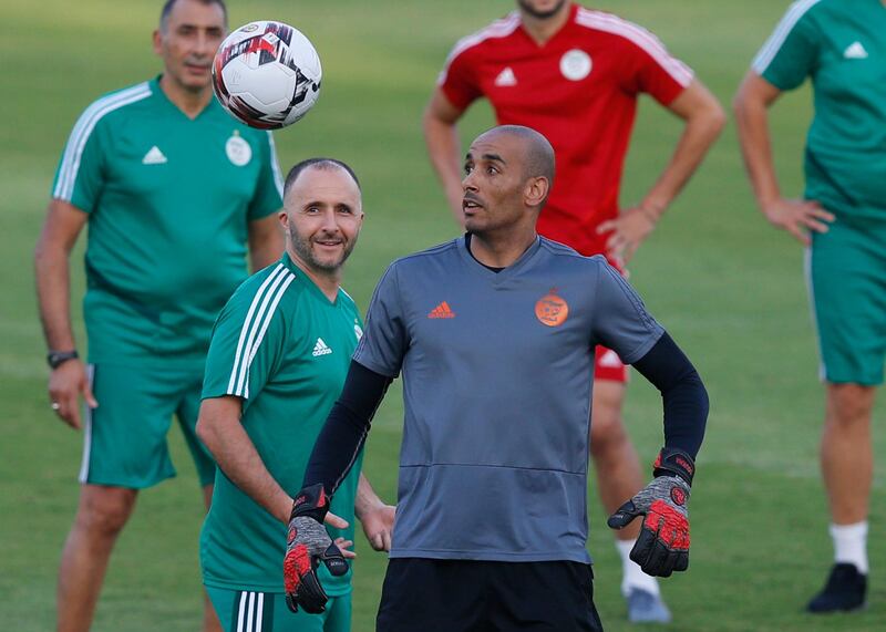 Algeria's head coach Djamel Belmadi and Izzeddine Doukha watch the ball. AP Photo