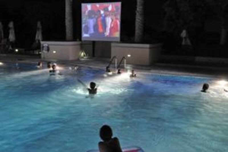 Kids enjoy the pool and watch a movie at Cine-Splash at the Dubai Polo and Equestrian Club.