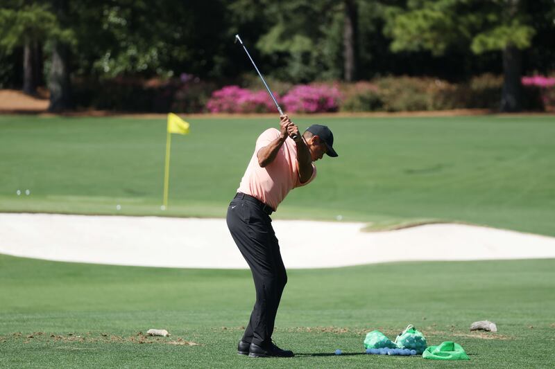 Tiger Woods warms up in the practice area Augusta National Golf Club as he tests out his fitness ahead of The Masters. AFP