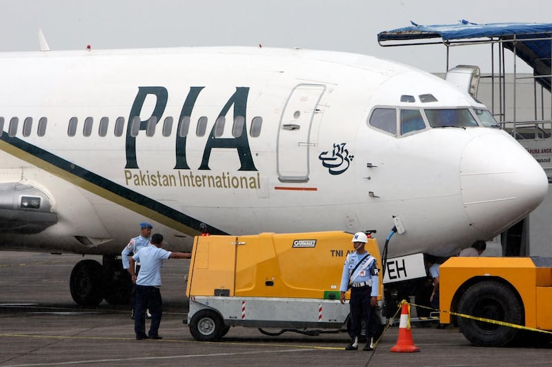 FILE - In this March 7, 2011 file photo, a Pakistan International Airlines passenger jet is parked on the tarmac at a military base in Makassar, Indonesia. The spokesman of Pakistanâ€™s national carrier said Wednesday, July 8, 2020, that the airline is firing 28 pilots found to have tainted licenses, the latest chapter in a scandal that emerged in the wake of the Airbus A320 crash in Karachi in May. An inquiry into the crash, which killed 97 people on board, resulted in the stunning revelation that 260 of 860 pilots in Pakistan had cheated on their pilots exams, but were still given licences by the Civil Aviation Authority. (AP Photo, File)