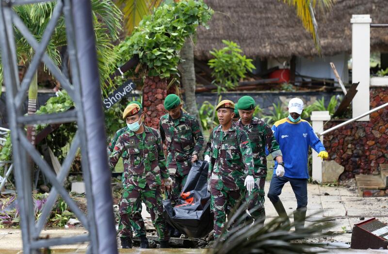 Indonesian soldiers and rescuers carry the bodies of victims at Tanjung Lesung beach resort. AP