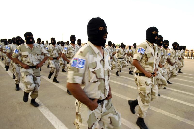 Soldiers from the self-styled army of Libyan Strongman Khalifa Haftar take part in a military parade in the eastern city of Benghazi on May 7, 2018, during which Haftar announced a military offensive to take from "terrorists" the city of Derna, the only part of eastern Libya outside his forces' control. / AFP PHOTO / Abdullah DOMA