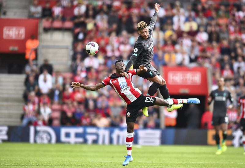 Southampton's Malian midfielder Moussa Djenepo (L) vies with Liverpool's English midfielder Alex Oxlade-Chamberlain (R) during the English Premier League football match between Southampton and Liverpool at St Mary's Stadium in Southampton, southern England on August 17, 2019. (Photo by Glyn KIRK / AFP) / RESTRICTED TO EDITORIAL USE. No use with unauthorized audio, video, data, fixture lists, club/league logos or 'live' services. Online in-match use limited to 120 images. An additional 40 images may be used in extra time. No video emulation. Social media in-match use limited to 120 images. An additional 40 images may be used in extra time. No use in betting publications, games or single club/league/player publications. / 