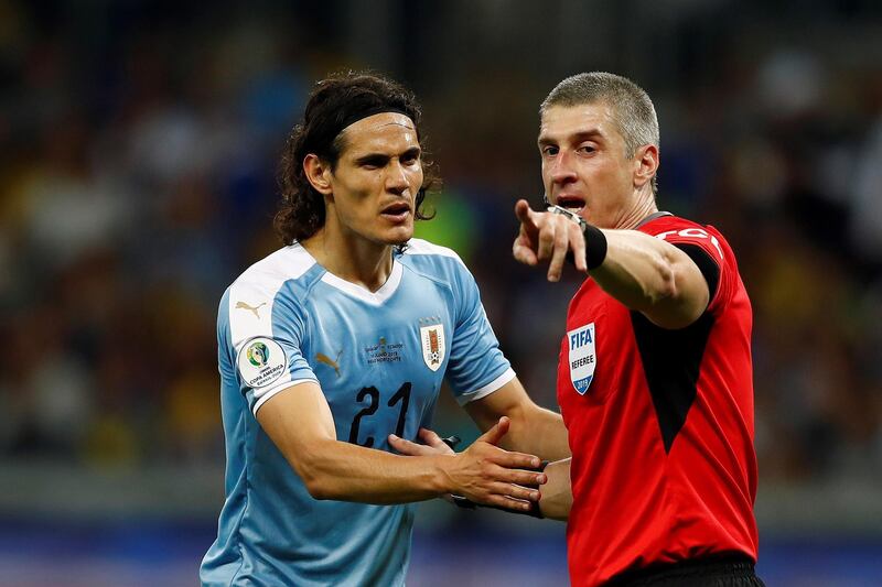 The referee Anderson Daronco (R) talks to Edinson Cavani (L) of Ururguay during the Copa America 2019 Group C soccer match between Uruguay and Ecuador, at the Mineirao Stadium in Bello Horizonte, Brazil. EPA