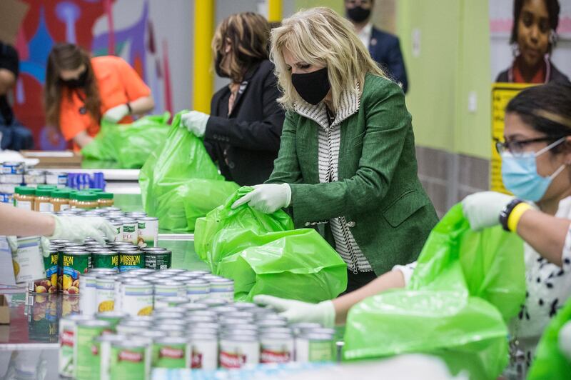 First Lady Jill Biden helps pack a backpack buddy bag of food at the Houston Food Bank, in Houston. AP Photo