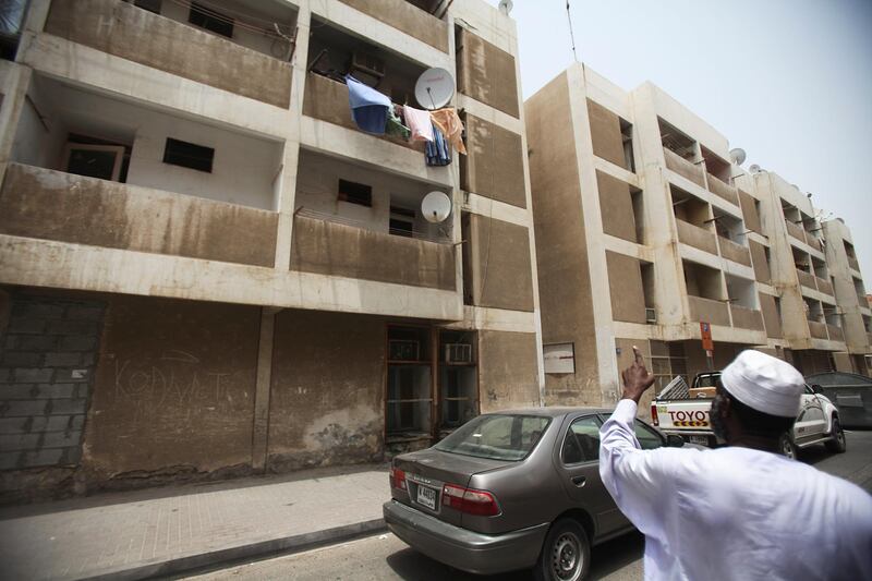Dubai, UAE, July 8, 2012:
Ahmed Omar, a native of Sudan, is seen here, pointing to his apartment. He has been living inside of the Sheikh Rashid Colony (also known as the 7,000 building because of its original rental price) for 11 and a half years. He doesn't know where he and his family will go yet. 

The residents of the area were told on June 1st via text message that they would have to vacate their homes by mid july at the very latest. 

Lee Hoagland/The National