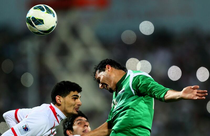 Hussam al-Sarry (R) of Iraq vies with Mohannad Salem of UAE as he attempts to score during the 21st Gulf Cup's final between United Arab Emirates (UAE) and Iraq on January 18, 2013 in Manama. United Arab Emirates won 2-1 against  Iraq.  AFP PHOTO/MARWAN NAAMANI
 *** Local Caption ***  291256-01-08.jpg