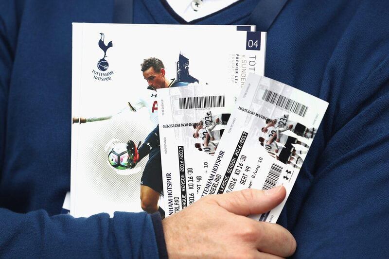 Tottenham Hotspur fan holds his tickets and a match day programme ahead of the Premier League match against Sunderland. Julian Finney / Getty Images