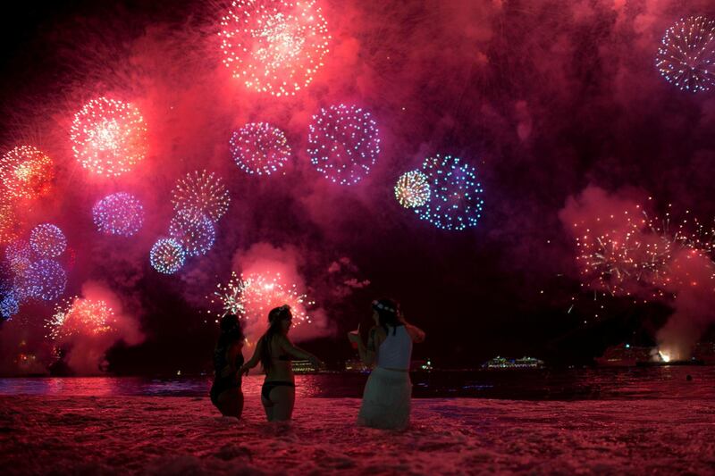 People watch New Year fireworks explode over Copacabana beach in Rio de Janeiro, Brazil. Lucas Landau / Reuters