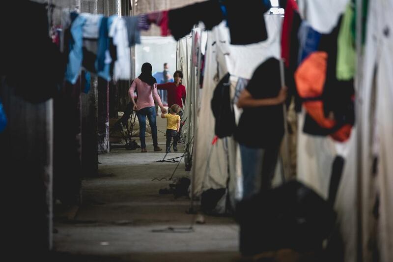 Refugees wait out their applications for EU asylum, piecing together a basic existence in the warehouse of the Softex toilet roll factory, Thessaloniki. Photo Gabriele François Casini / Save the Children.