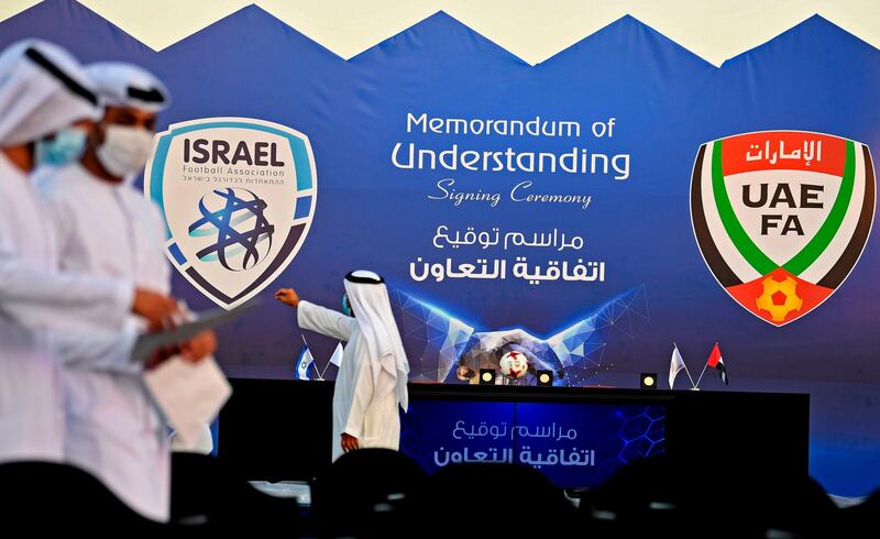 Emiratis chat ahead of a ceremony for the signing of a memorandum of understanding between the UAE and the Israeli football associations in Dubai.  AFP