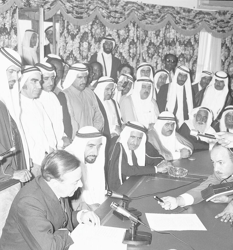 1971. President Shaikh Zayed Bin Sultan Al Nahyan with the other rulers of the emirates, government representatives and media listen to the British political agent as he reads the document proclaiming the federation and the UAE's independence. - WAM