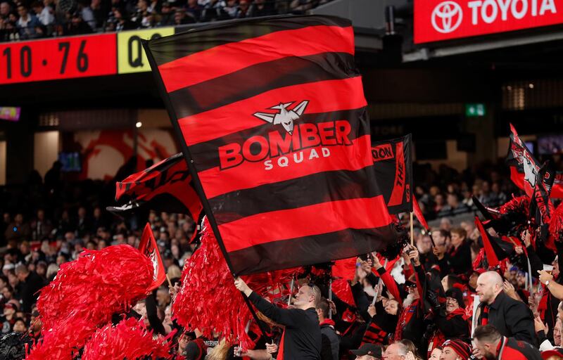 Bombers fans cheer during the AFL match between the Collingwood Magpies and the Essendon Bombers at the Melbourne Cricket Ground on Sunday, April 25. Getty