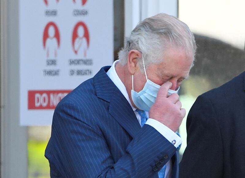 Prince Charles speaks with a member of staff. AP Photo